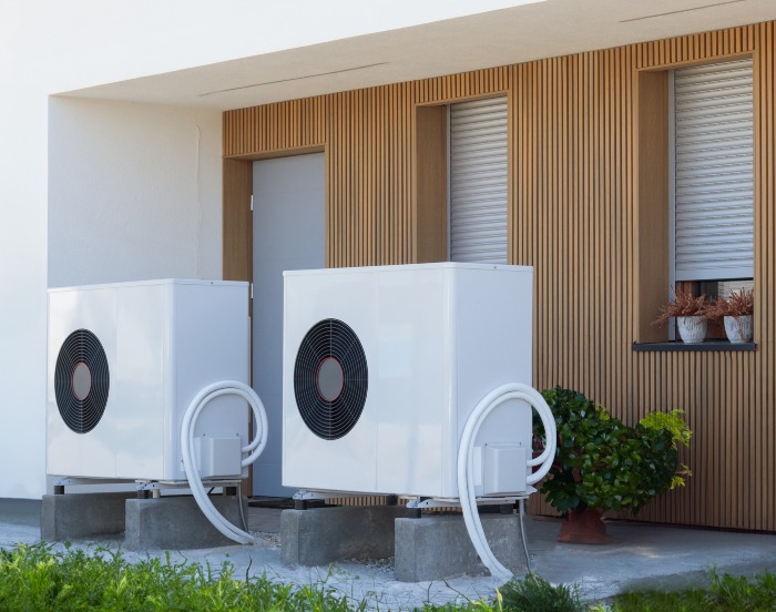 Heat pump installed outside a modern home – Triple-T